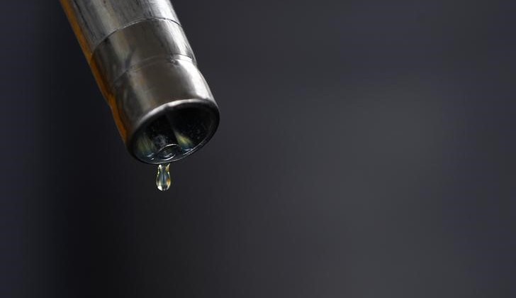 A drop of diesel is seen at the tip of a nozzle after a fuel station customer fills her car's tank in Sint Pieters Leeuw