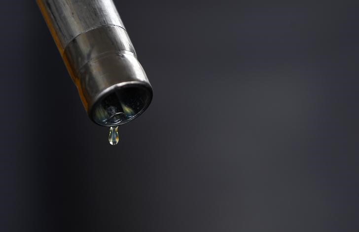 A drop of diesel is seen at the tip of a nozzle after a fuel station customer fills her car's tank in Sint Pieters Leeuw
